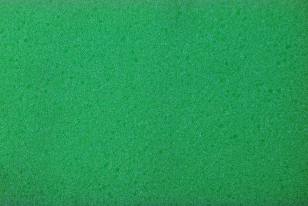一块泡沫橡胶的绿色塑料背景照片