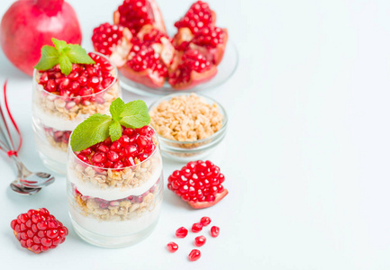 石榴馅饼甜有机分层甜点与格兰诺拉片酸奶和成熟的水果种子在美丽的