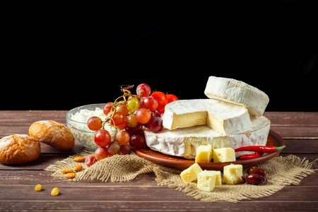 把不同类型的奶酪放在木桌上图片