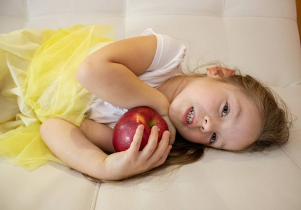 迷人的小女孩手里拿着一个红苹果