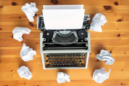 s block. Typewriter and crumpled paper on work desk. Creative pr