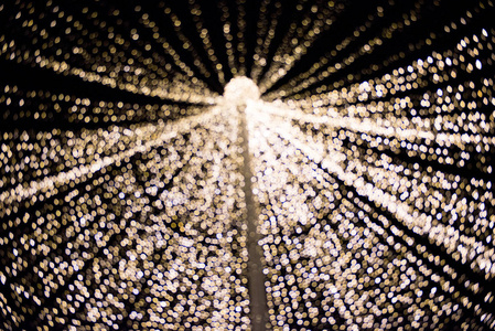 圣诞城市灯光的抽象背景。 模糊的离焦，明亮的发光圆圈在深色图案上