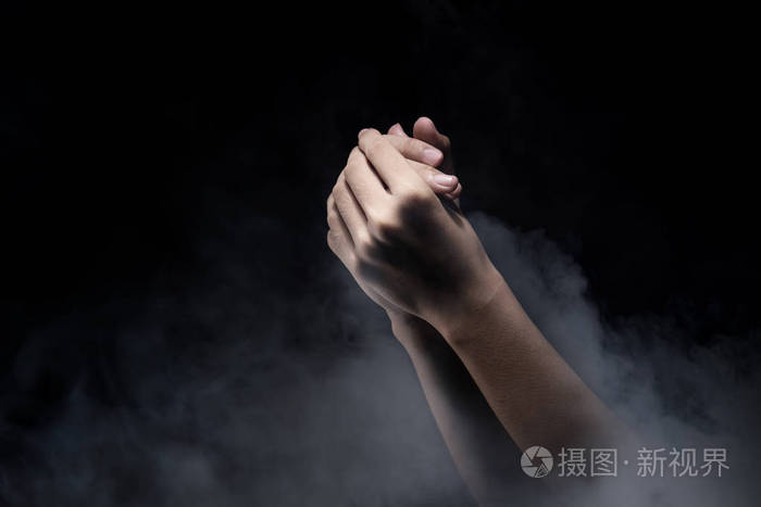 祈祷手放在黑暗的背景上. 基督教祈祷