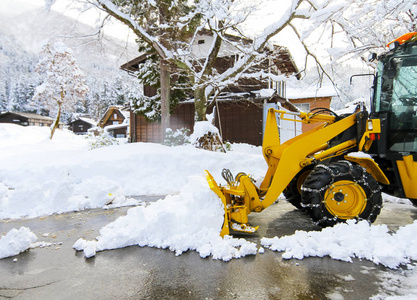 在村里的道路上清除雪的雪装载机