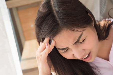  depressed woman suffers from stress, vertigo, dizziness, migrai