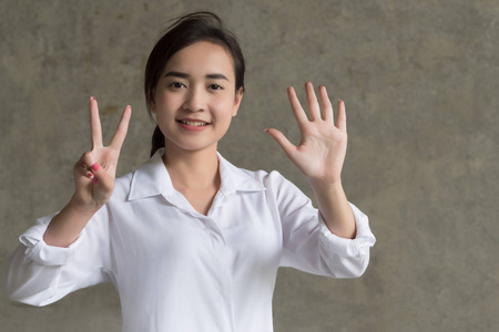  portrait of positive happy smiling asian businesswoman pointing