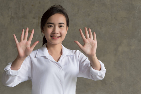  portrait of positive happy smiling asian businesswoman pointing