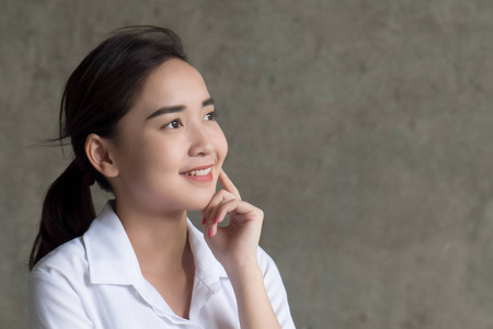  portrait of asian woman looking up, thinking, finding good idea