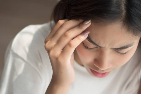  depressed woman suffers from vertigo, dizziness, migraine, hang