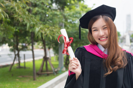  portrait of diploma or college woman student with graduation de