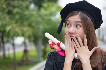  portrait of surprised woman student with graduation diploma or 