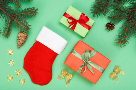 s boot, gift box, fir tree branches with cones and christmas toy