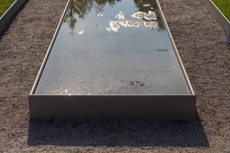 在德国南部的室外公园里，巴洛克雕像展示了自己在水盆中的镜像