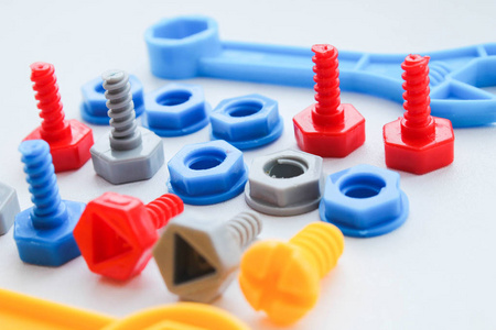 s plastic toy bolts and nuts on an isolated background