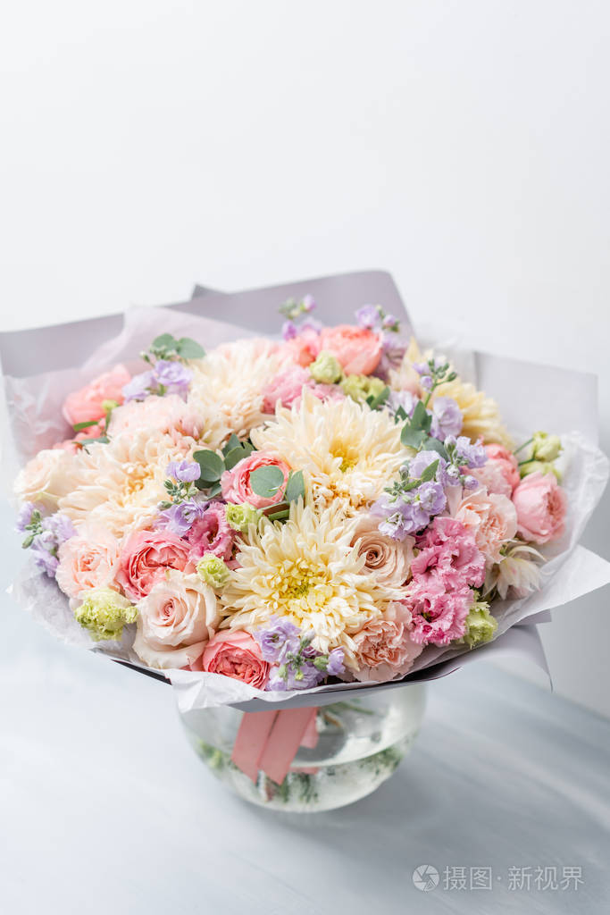 美丽的春天花束在玻璃花瓶.安排与各种花卉.花店的概念.