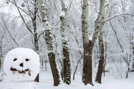 冬天森林里微笑的雪人。圣诞快乐。新年庆典。霜雪背景..冬季户外装饰。可怕的雪人。