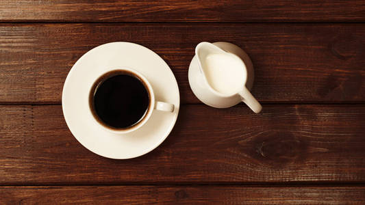 一杯加牛奶的咖啡放在木桌上