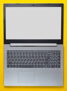 在黄色背景上打开笔记本电脑。 现代计算机技术。 上面的风景。