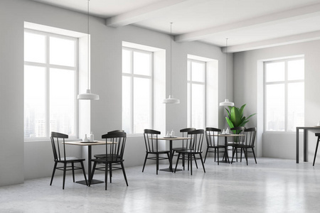 现代咖啡馆的角落,白色的墙壁,灰色的地板,许多窗户和木制的桌子,圆形