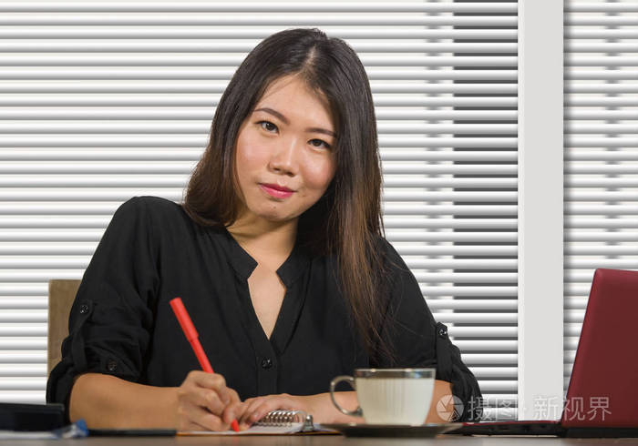 年轻美丽成功的亚洲商界女性，在现代办公室电脑桌上自信地工作，在女商人的成功和公司的工作理念上充满自信
