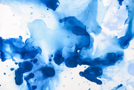 美丽的蓝色酒精墨水溅在白色上，作为抽象的背景