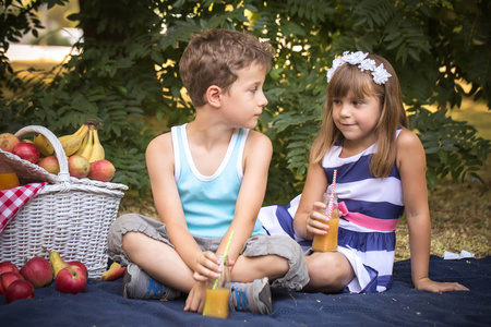 s eyes. First love. Near the boy there is a picnic basket with j