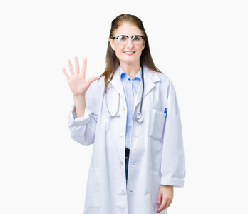 中年成熟的医生女人穿着医用外套，在孤立的背景下，用手指第五，微笑着自信和快乐。