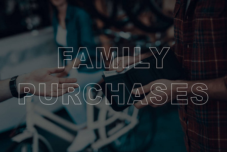 家庭购买。 顾客买了一辆自行车。 从钱包里给推销员钱的人。 推销员拿钱。 钱是一百美元的美国。 自行车店。 特写镜头。 有背景的