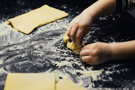 s hands learn to make dessert, playing with flour.