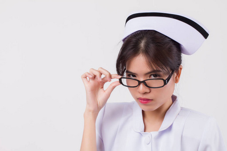  isolated portrait of asian female nurse in negative, unfriendly