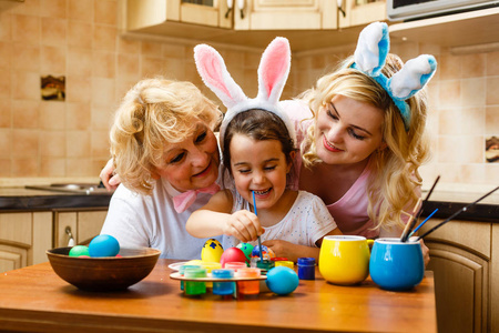 幸福的家庭在家里画复活节彩蛋