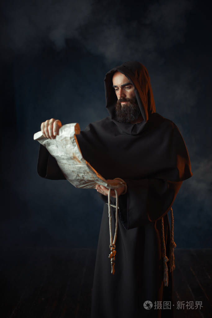 中世纪僧侣在古代手稿宗教中读祈祷神秘的修士穿着深色斗篷神秘与灵性