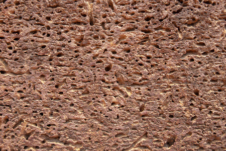 多孔砂岩表面..古老粗糙的天然石材纹理..风化石头特写..粗糙的表面照片背景。砂岩的扭曲纹理。粗糙的火山岩结构