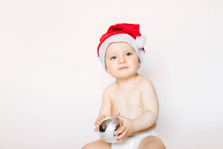 s cap and holding a silver Christmas tree toy, isolated on the w