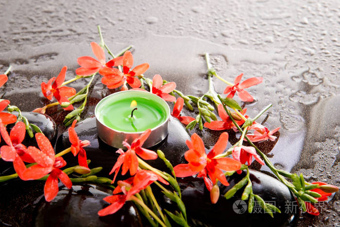 橙红色的罗夏花 黑色的按摩石和绿色的茶色蜡烛 水滴在湿灰色的石板背景上照片 正版商用图片q 摄图新视界