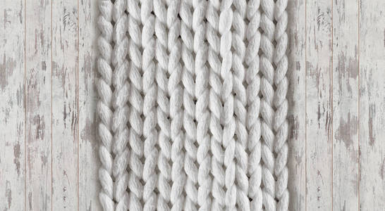 三维壁纸羊毛手工编织大毛毯上白橡木刷背景潮流概念。 针织毛毯美利奴羊毛背景