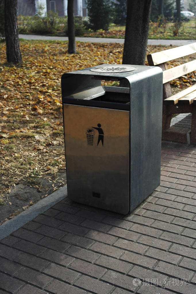 街凳旁边的现代垃圾桶