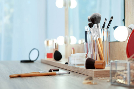 组织者与化妆品产品化妆在桌子附近的镜子。 文本空间