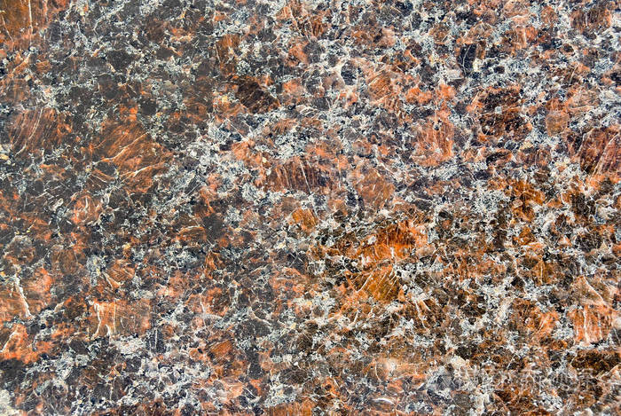 天然抛光花岗岩石材的美丽纹理。 在图像上有很多不同的颜色尺度。