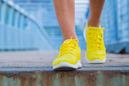 s running shoes while walking towards the camera.