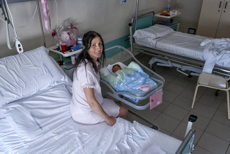 幸福的母亲和她的新生儿在医院的房间里。