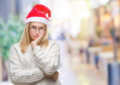 年轻的高加索女人戴着圣诞帽，在孤立的背景下思考，看起来疲惫，厌倦了交叉双臂的抑郁问题。