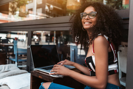  cheerful Brazilian businesswoman with curly afro hair during a 