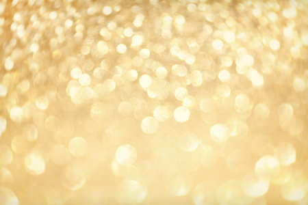 金光闪闪，有波克效应和选择性聚焦。 节日背景与明亮的金灯香槟泡沫。 圣诞情绪概念。 复制空间关闭纹理顶部视图。