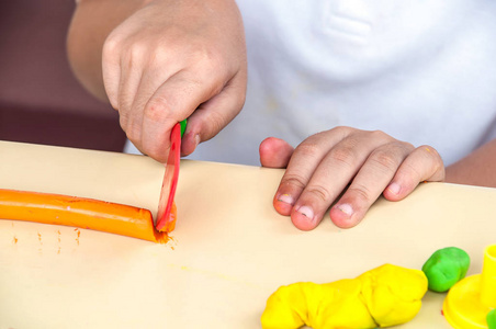 s hands playing clay