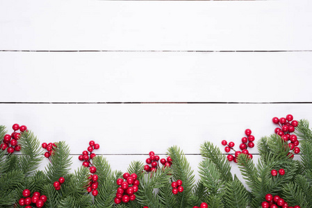 s composition. Top view of spruce branches, pine cones, red berr