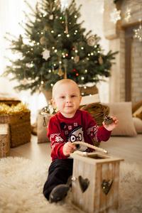 s toy car on background of the Christmas tree and festive garlan