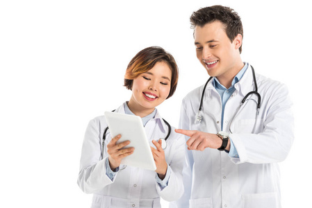 微笑的女性和男性医生用数码平板分离在白色上的听诊器