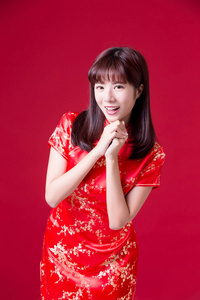 在中国的新年里，美女穿着旗袍向你微笑