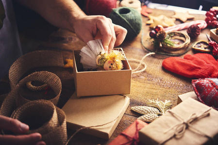 s hands holding open gift box a preparing christmas gifts. Chris